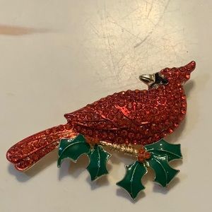 A cardinal pin with rhinestones and enamel